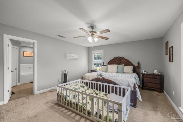 carpeted bedroom featuring visible vents, baseboards, and ceiling fan