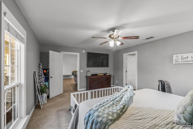 bedroom featuring visible vents, baseboards, ceiling fan, and carpet flooring