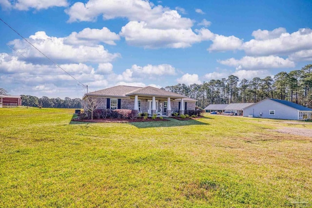 view of front of home featuring covered porch and a front yard