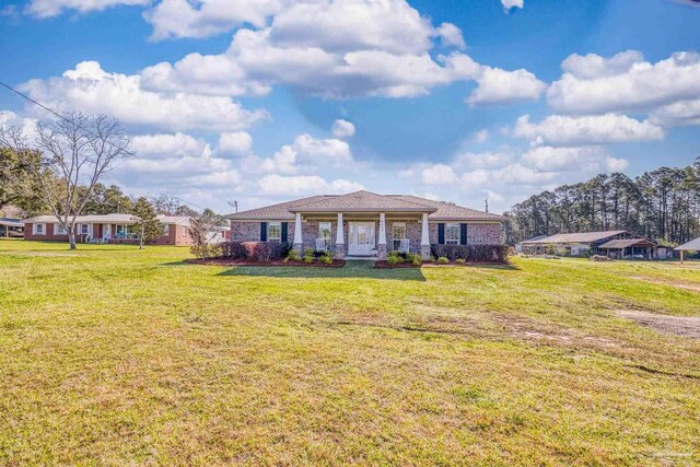 view of front of house with a front yard and a porch