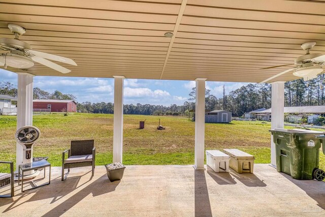 view of patio / terrace with a ceiling fan, a storage shed, and an outdoor structure