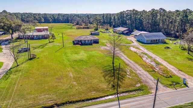 bird's eye view with a rural view and a wooded view