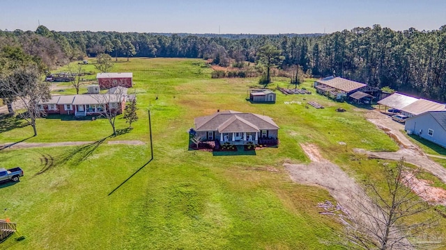 drone / aerial view with a wooded view