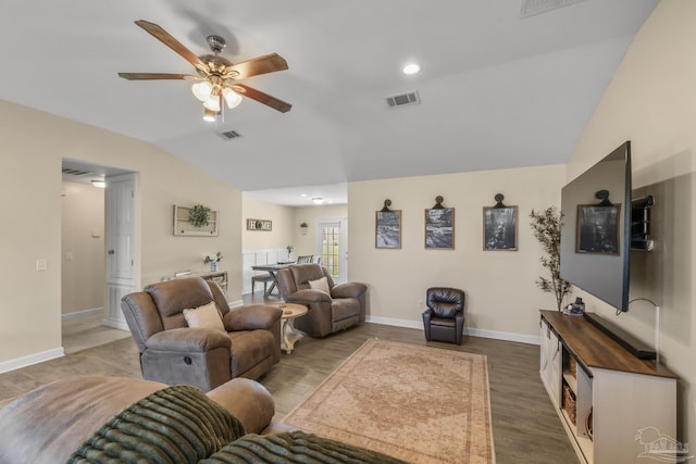 living room with visible vents, a ceiling fan, wood finished floors, baseboards, and vaulted ceiling