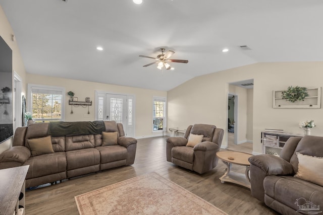 living room featuring visible vents, wood finished floors, recessed lighting, baseboards, and lofted ceiling