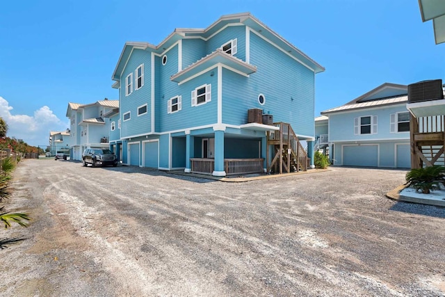 1299 Ft Pickens Rd Unit 6, Pensacola Beach, FL 32561 - rear view of house featuring stairway, driveway, and an attached garage