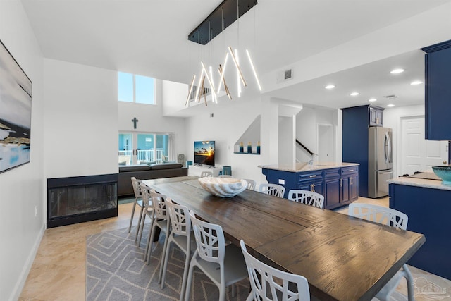 1299 Ft Pickens Rd Unit 6, Pensacola Beach, FL 32561 - dining space with visible vents, baseboards, a high ceiling, recessed lighting, and a multi sided fireplace