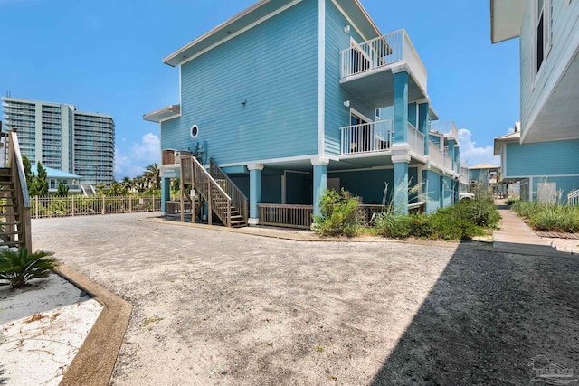 1299 Ft Pickens Rd Unit 6, Pensacola Beach, FL 32561 - rear view of house with stairway