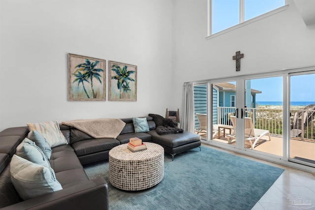 1299 Ft Pickens Rd Unit 6, Pensacola Beach, FL 32561 - living room featuring a wealth of natural light, tile patterned floors, a towering ceiling, and a water view