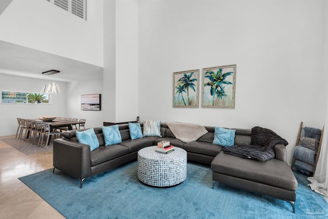 1299 Ft Pickens Rd Unit 6, Pensacola Beach, FL 32561 - living area featuring tile patterned flooring, visible vents, and a high ceiling