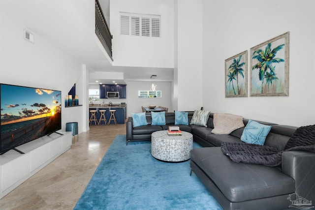 1299 Ft Pickens Rd Unit 6, Pensacola Beach, FL 32561 - living room with visible vents and a towering ceiling