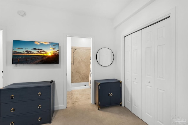 1299 Ft Pickens Rd Unit 6, Pensacola Beach, FL 32561 - bedroom featuring a closet, light colored carpet, and ensuite bathroom