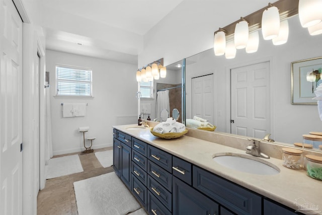 1299 Ft Pickens Rd Unit 6, Pensacola Beach, FL 32561 - bathroom with a sink, baseboards, a shower with shower curtain, and double vanity