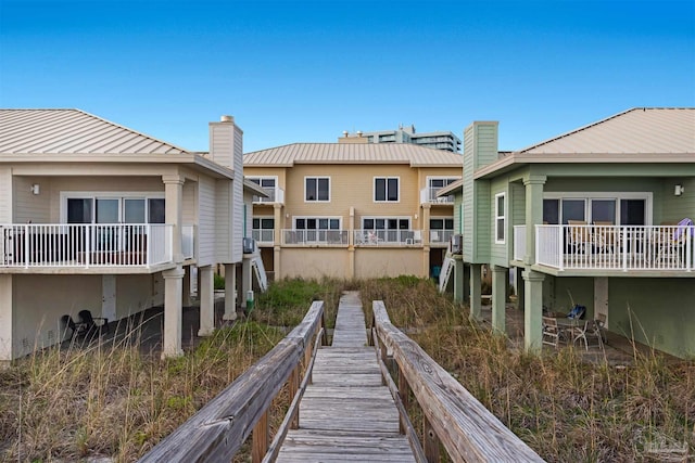1299 Ft Pickens Rd Unit 6, Pensacola Beach, FL 32561 - back of house with a chimney and metal roof