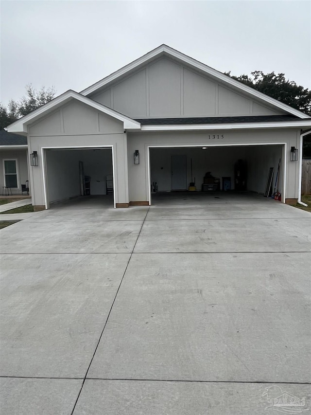 1315 W Scott St, Pensacola, FL 32501 - exterior space with driveway, board and batten siding, and a garage