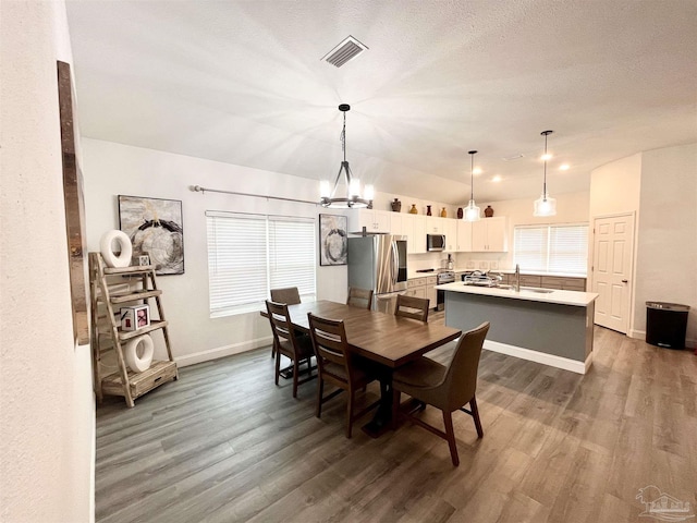 1315 W Scott St, Pensacola, FL 32501 - dining room with an inviting chandelier, a wealth of natural light, visible vents, and dark wood-type flooring