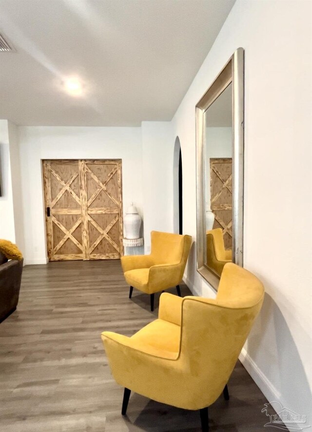 1315 W Scott St, Pensacola, FL 32501 - living area featuring visible vents, wood finished floors, and baseboards
