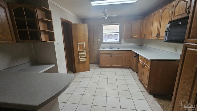 kitchen with ceiling fan, sink, light tile patterned floors, and ornamental molding