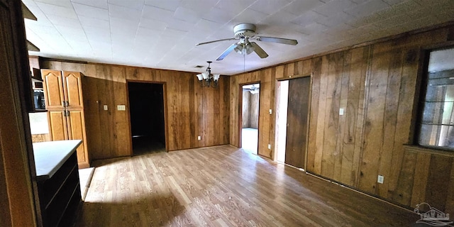 interior space featuring light hardwood / wood-style flooring and wood walls