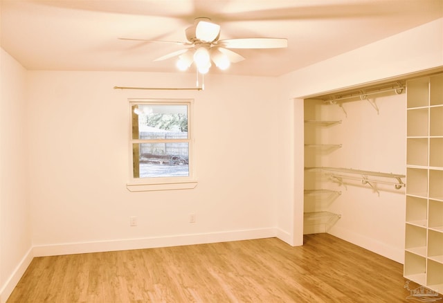 unfurnished bedroom featuring baseboards, ceiling fan, a closet, and light wood-style floors