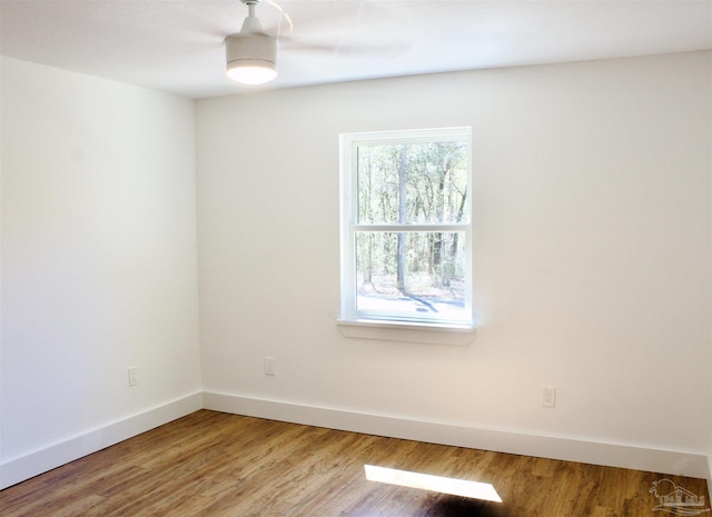 empty room with light wood-style flooring and baseboards