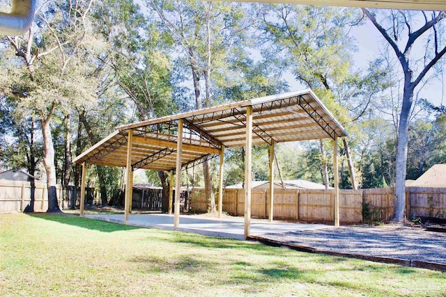 view of yard featuring a carport and a fenced backyard