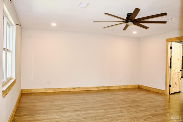 unfurnished room featuring light wood-type flooring, baseboards, and recessed lighting