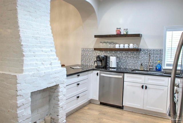 kitchen with dishwasher, light hardwood / wood-style flooring, tasteful backsplash, sink, and white cabinetry