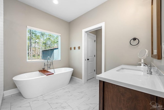 bathroom with vanity and a washtub