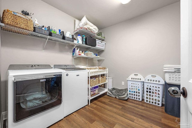 clothes washing area featuring washer and dryer and dark hardwood / wood-style flooring