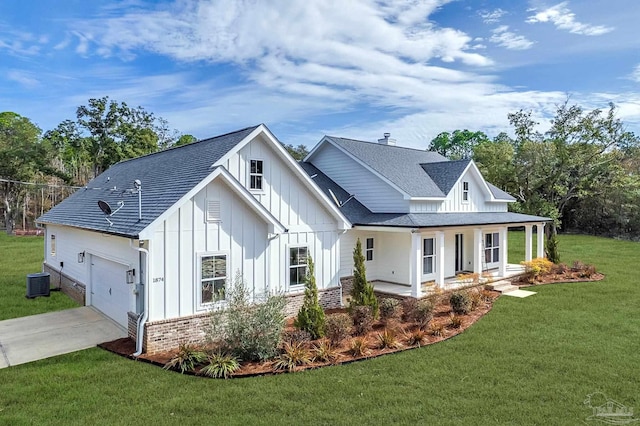 modern farmhouse style home with cooling unit, a garage, covered porch, and a front lawn