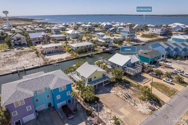 drone / aerial view with a water view and a residential view