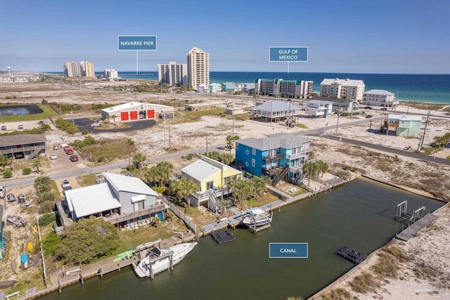 birds eye view of property with a water view and a city view