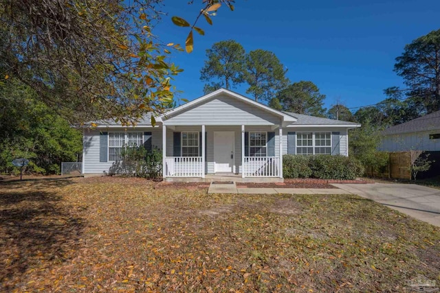 ranch-style home with a porch and a front yard