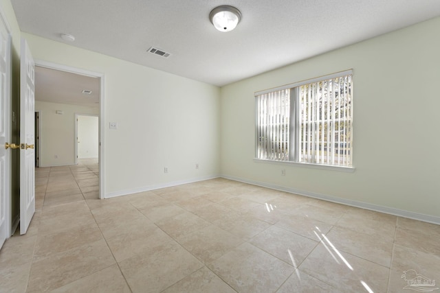 spare room featuring light tile patterned floors