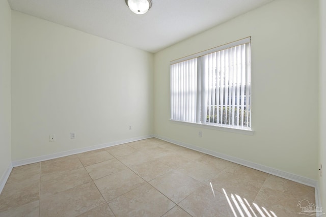 tiled empty room featuring a healthy amount of sunlight