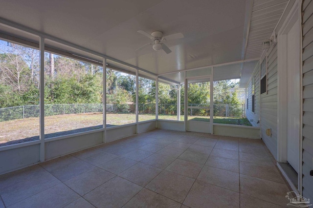 unfurnished sunroom featuring ceiling fan