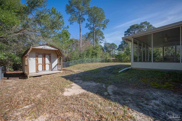 view of yard featuring a sunroom and a shed