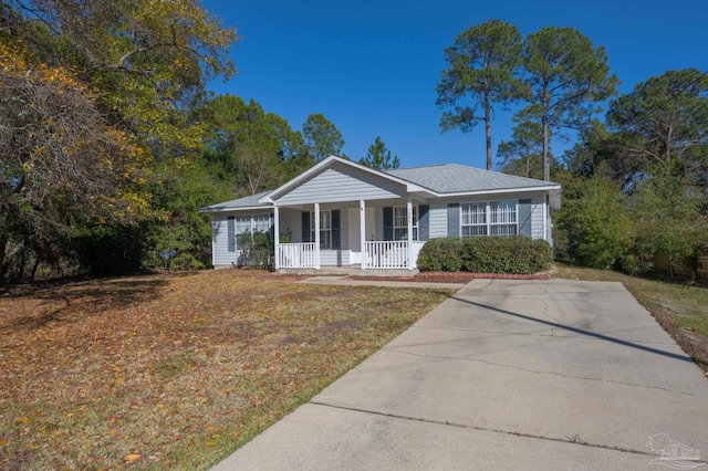 single story home featuring covered porch and a front yard