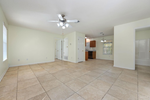 unfurnished living room featuring light tile patterned flooring and ceiling fan with notable chandelier