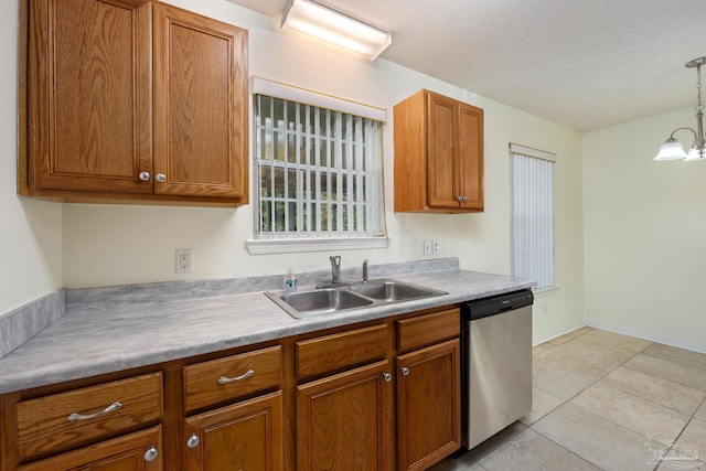 kitchen featuring sink, stainless steel dishwasher, a notable chandelier, pendant lighting, and light tile patterned floors