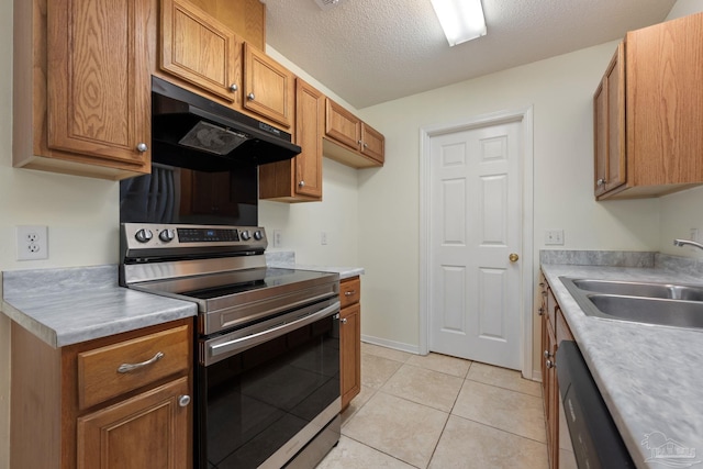 kitchen featuring dishwasher, sink, a textured ceiling, stainless steel range with electric stovetop, and light tile patterned flooring