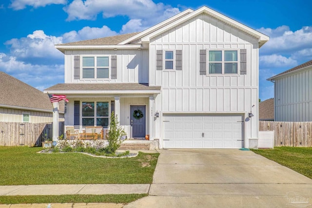 front of property with a garage, a porch, and a front lawn