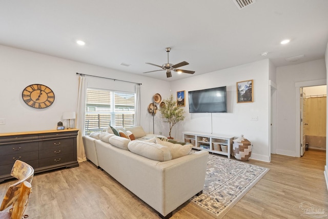 living room featuring ceiling fan and light hardwood / wood-style flooring