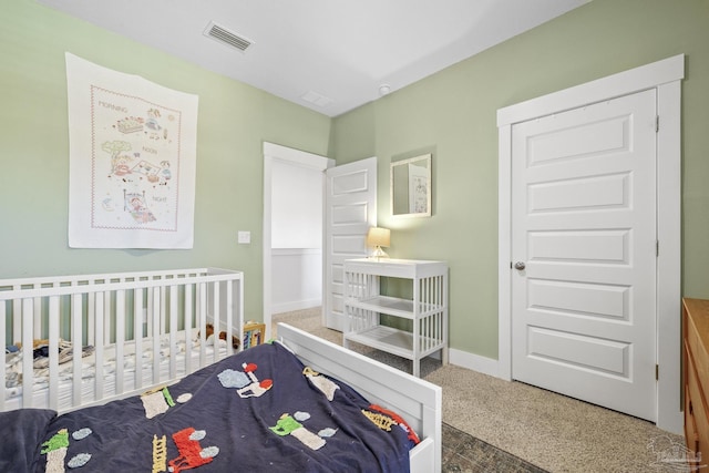 bedroom with carpet flooring and a crib