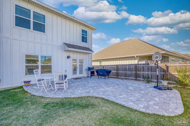 rear view of house with a lawn and a patio