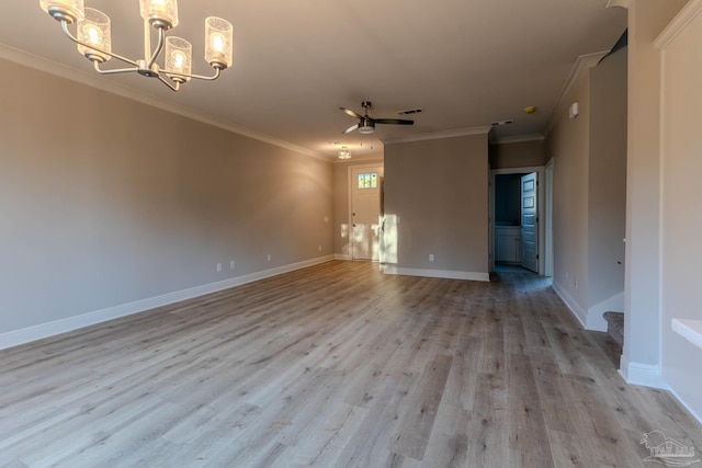 empty room featuring light hardwood / wood-style floors, crown molding, and ceiling fan with notable chandelier