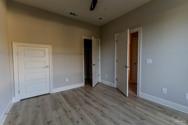 unfurnished bedroom with ceiling fan and light wood-type flooring