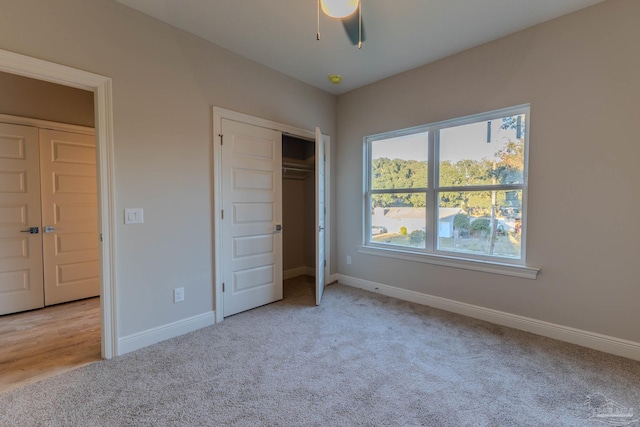 unfurnished bedroom with light colored carpet and ceiling fan