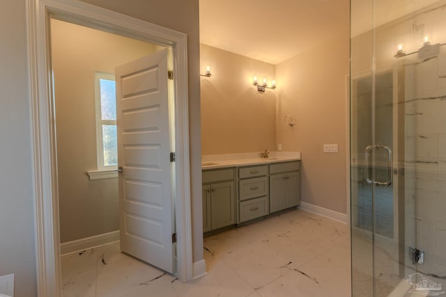 bathroom featuring a shower with door and vanity